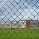 high-school-building-behind-a-fence